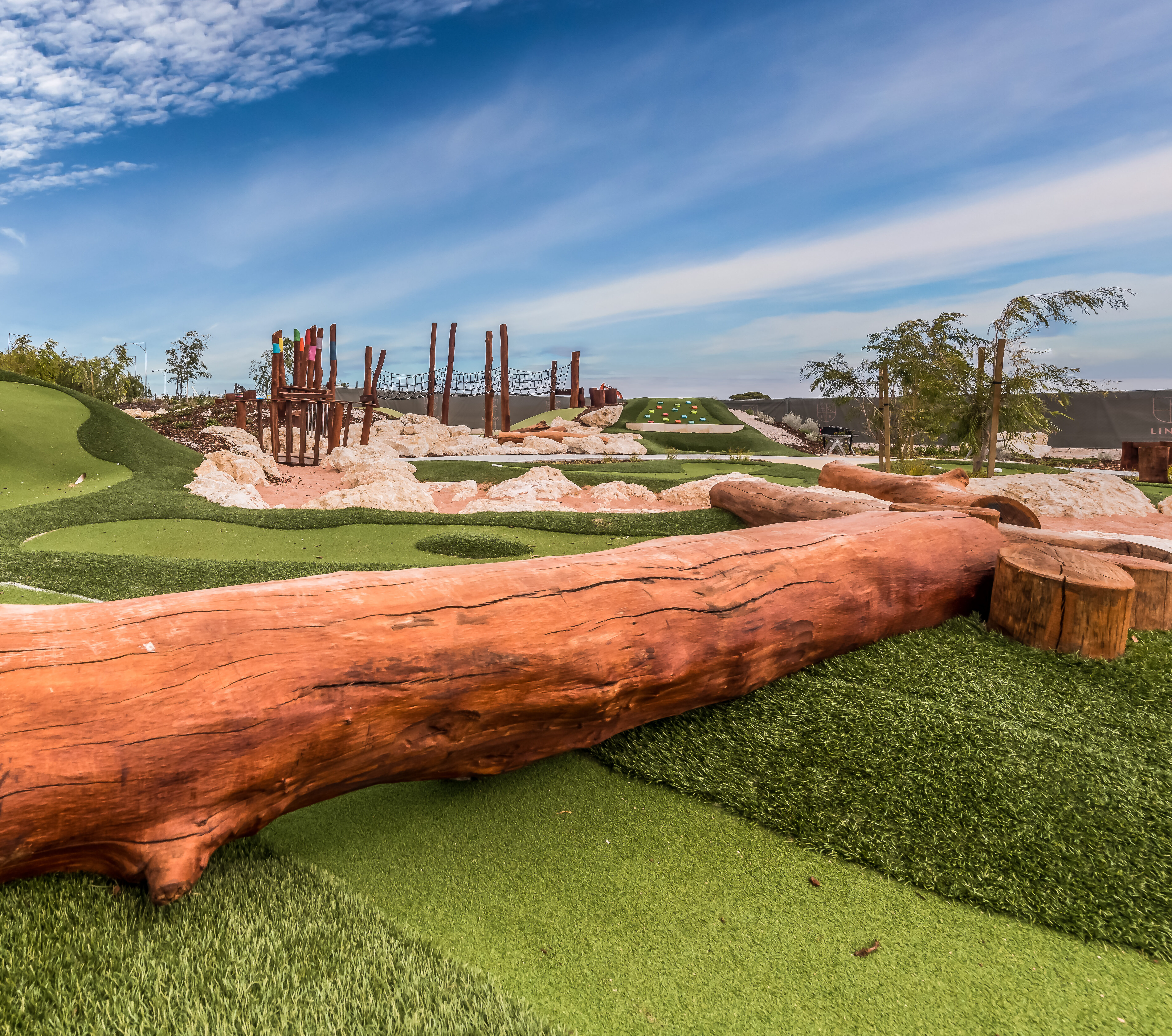Log | Create engaging play pathways and natural landscape features with our Jarrah logs, perfect for climbing, balancing, and defining playful spaces in outdoor environments. | VRI