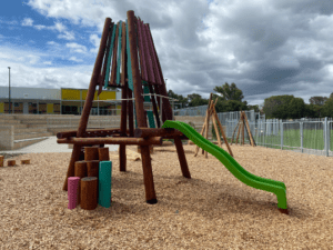Experience our Sunningdale Tower, featuring climbing wall, rope platform, and vibrant slide. Crafted from sustainable WA Jarrah with customisable colour options, perfect for adventure play.