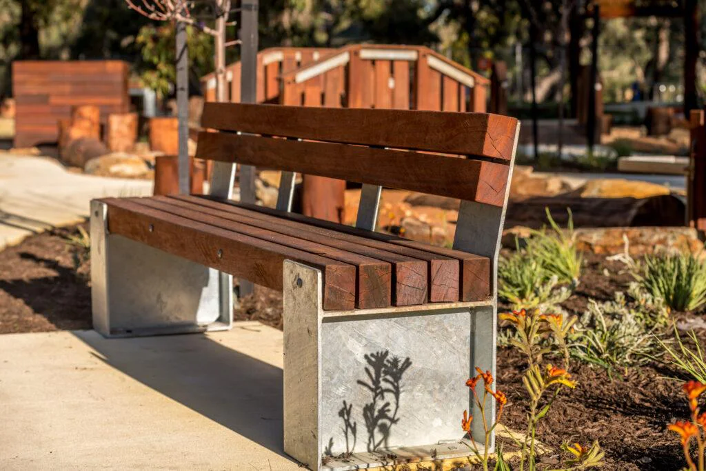 Commercial Jarrah outdoor bench seating at Sandy Beach playground — VRI Seating & Shelter 800 Series