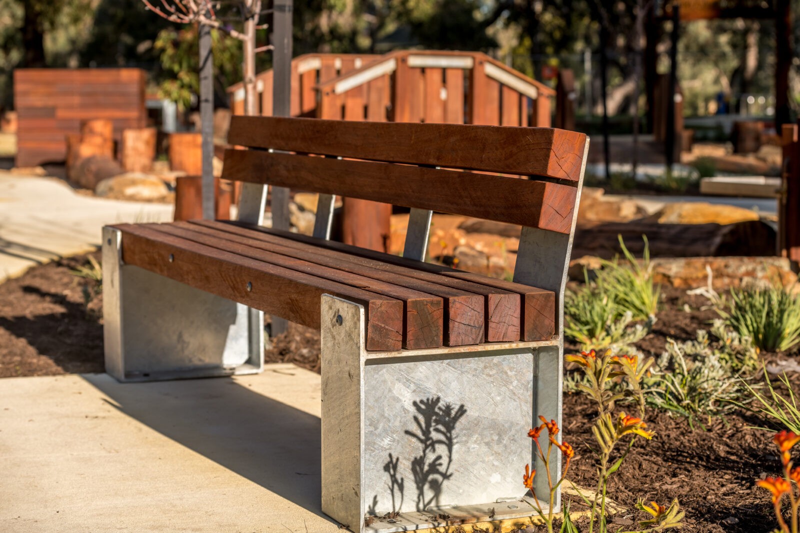 Bench Seat Type B with Backrest | Provide comfortable, traditional seating with this bench featuring West Australian Jarrah battens, a supportive slanted backrest, and a durable steel frame for lasting appeal. | VRI