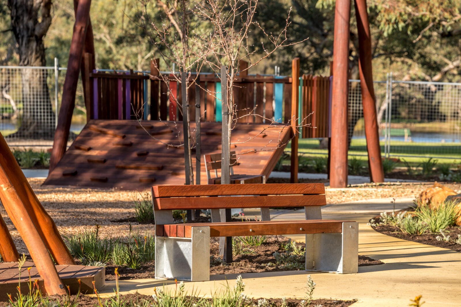 Bench Seat Type B with Backrest | Provide comfortable, traditional seating with this bench featuring West Australian Jarrah battens, a supportive slanted backrest, and a durable steel frame for lasting appeal. | VRI