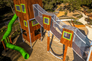 Transform your playground with our towering 8.7-metre adventure structure, featuring multiple climbing challenges, mesh-enclosed walkways, and an exhilarating giant tube slide for the ultimate play experience.
