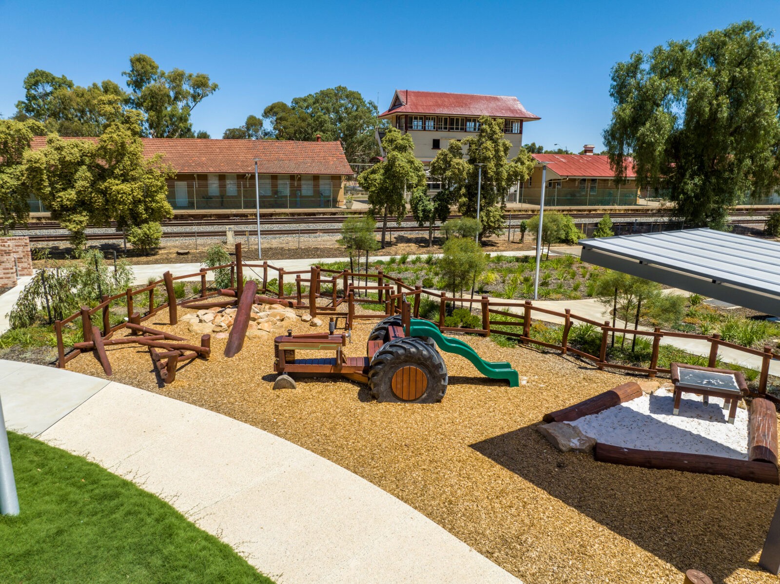 Tractor | Cultivate playground fun with this West Australian Jarrah Tractor, featuring salvaged tyres, stainless steel detailing, bench seat platform with slide, and open engine bay for imaginative farm play. | VRI