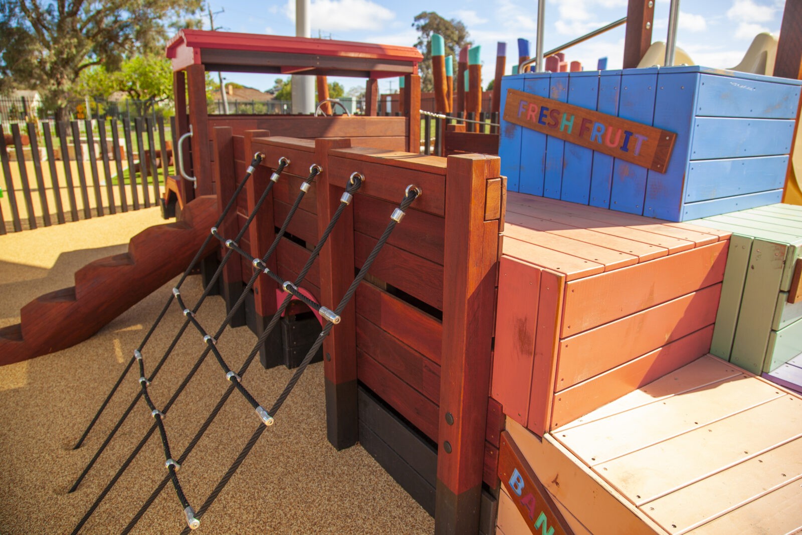 Loaded Fruit Truck | Experience feature-packed fun with the Loaded Fruit Truck, boasting colourful stacked crate climbers, nets, slide, log steps, and a unique under-tray tunnel. | VRI