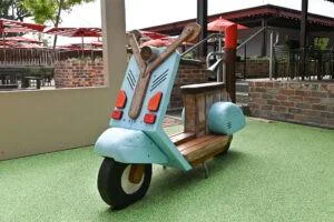 Custom moped play element at The Bayswater Hotel pub playground Perth — handcrafted timber and painted scooter