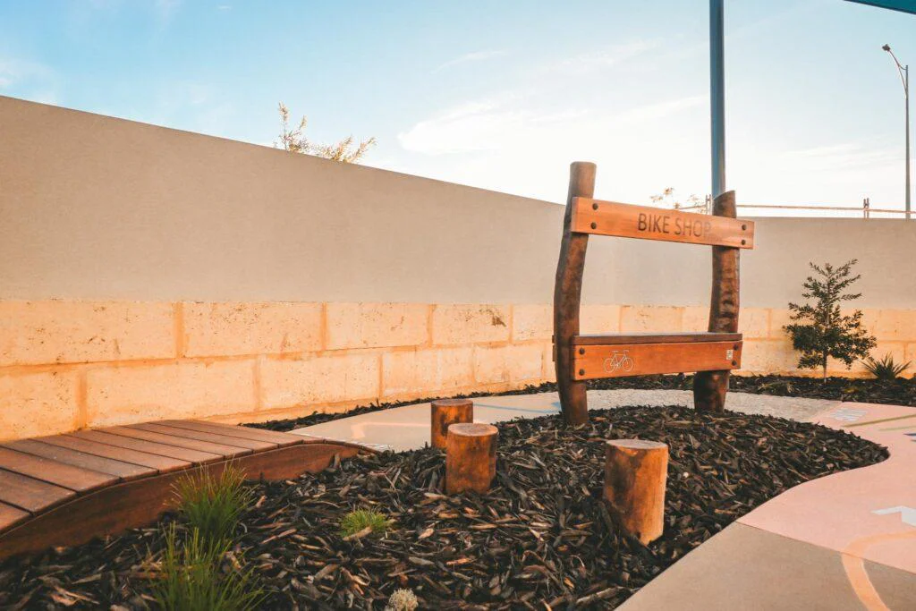 The Custom Bike Shop and timber bridge at Inspira Kids, demonstrating the early learning playground collaboration with Plan E.