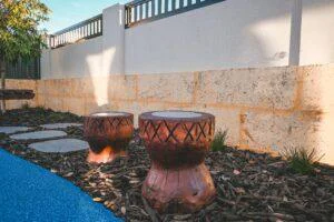 Two 773-DDR Djembe Drums in a garden at Inspira Kids Lakelands, part of an early learning playground collaboration.
