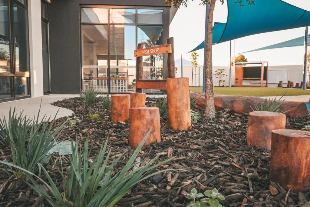 Custom Fish Shop and log stumps at the custom early learning playspace WA built for Inspira Kids Lakelands.