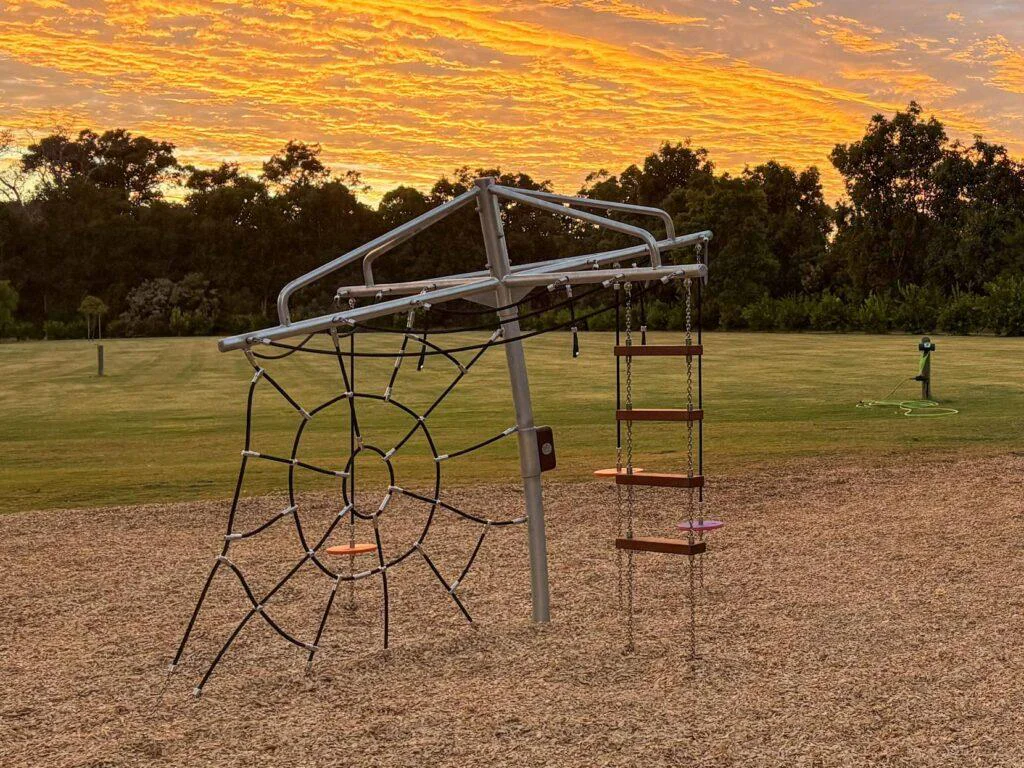 432-CLC Clothesline Climber — full structure sunset view showing elevated clothesline cable traverse and spider web net, commercial playground equipment