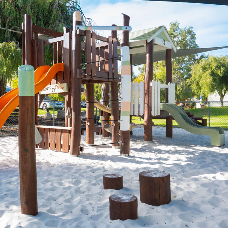 172-GFO Giddy-Up Forts — side view of dual-level Jarrah fort with Fowlers Stable signage and stainless steel speaking tube, Parmelia Park