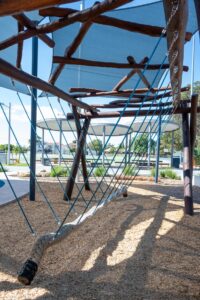 Van Ryt Industries 241-VWN Viking Swing with Nest Top — symmetrical perspective along the rope traverse showing blue tensioning ropes and central braided rope, Wilson Park