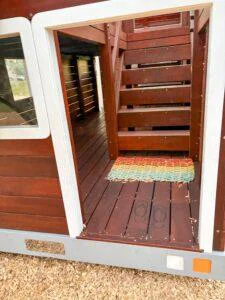 524-MTH Motorhome — door entry showing rubber doormat, engraved thongs in the deck and internal Jarrah staircase to upper deck