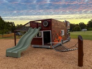 524-MTH Motorhome — rear three-quarter at dusk showing 1.8m double slide exit, rope net awning platform and hammock post