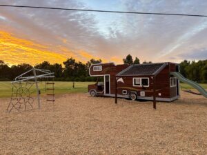 Holiday park playground equipment — 524-MTH Motorhome and 432-CLC Clothesline Climber at golden hour, BIG4 Dunsborough Southern Stars WA