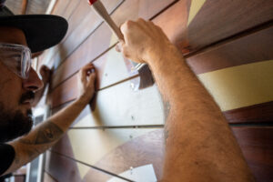 VRI craftsman applying Southern Stars gold star stencil detail to the 524-MTH Motorhome — bespoke holiday park playground equipment branding