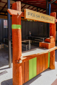Fresh Produce market stall with timber cash register — custom hospitality playground equipment at Charlie's Paddock