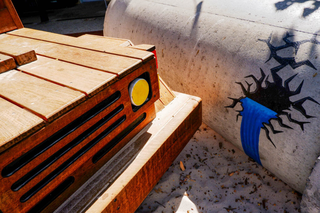 Timber Ute bonnet and Golden Pipeline concrete tunnel with heritage artwork at Charlie's Paddock playground