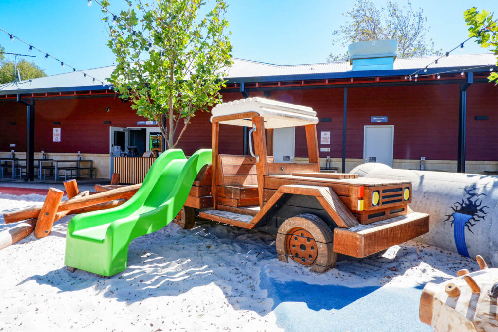 Timber Ute play vehicle with green slide and log scramble at Charlie's Paddock — Jarrah by Van Ryt Industries