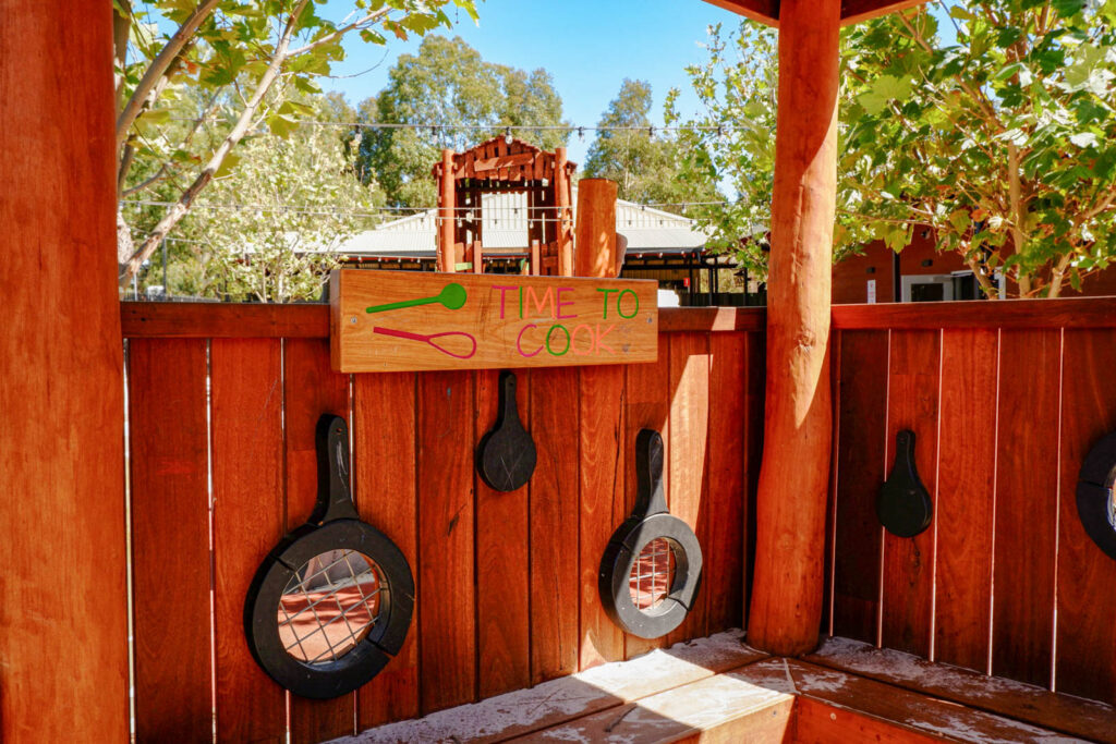 Time to Cook kitchen wall with play pans at Charlie's Paddock playground — custom imaginative play by VRI