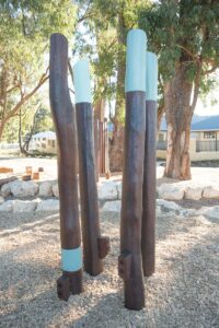 Row of Jarrah timber stilt steppers with painted teal colour accents at Hathaway Reserve playground Baldivis