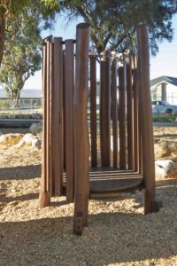 Jarrah timber stilt steppers in vertical arrangement with coloured accents at Hathaway Reserve playground Baldivis