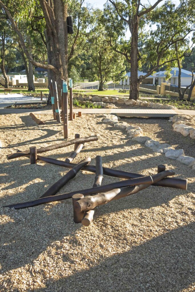 Jarrah timber log scramble play elements arranged in sand at Hathaway Reserve playground Baldivis