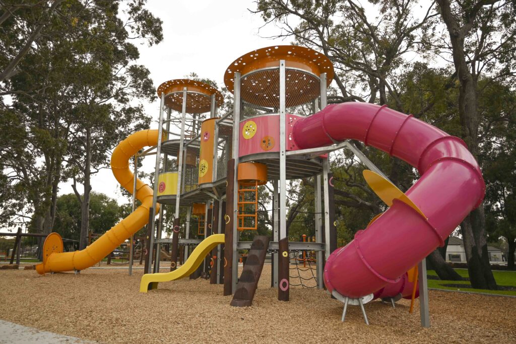 Maniana Mania Towers fuchsia tube slide and yellow open slide Maniana Park Queens Park by Van Ryt Industries
