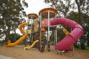 Maniana Mania Towers fuchsia tube slide and yellow open slide Maniana Park Queens Park by Van Ryt Industries