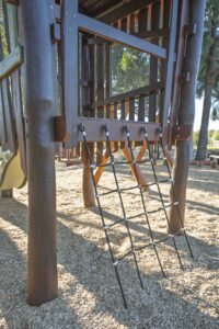 Ground level structural detail of Jarrah bushpole climbing tower showing rope fixings and chain connections at Hathaway Reserve playground Baldivis