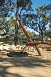 Jarrah timber cantilever pendulum swing with basket seat at Hathaway Reserve playground Baldivis, built by Van Ryt Industries