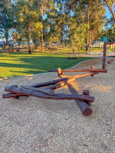 Overview of Jarrah timber nature playground with stilt steppers see saw and climbing tower at Hathaway Reserve Baldivis