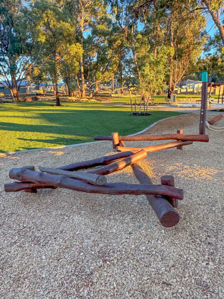 Overview of Jarrah timber nature playground with stilt steppers see saw and climbing tower at Hathaway Reserve Baldivis