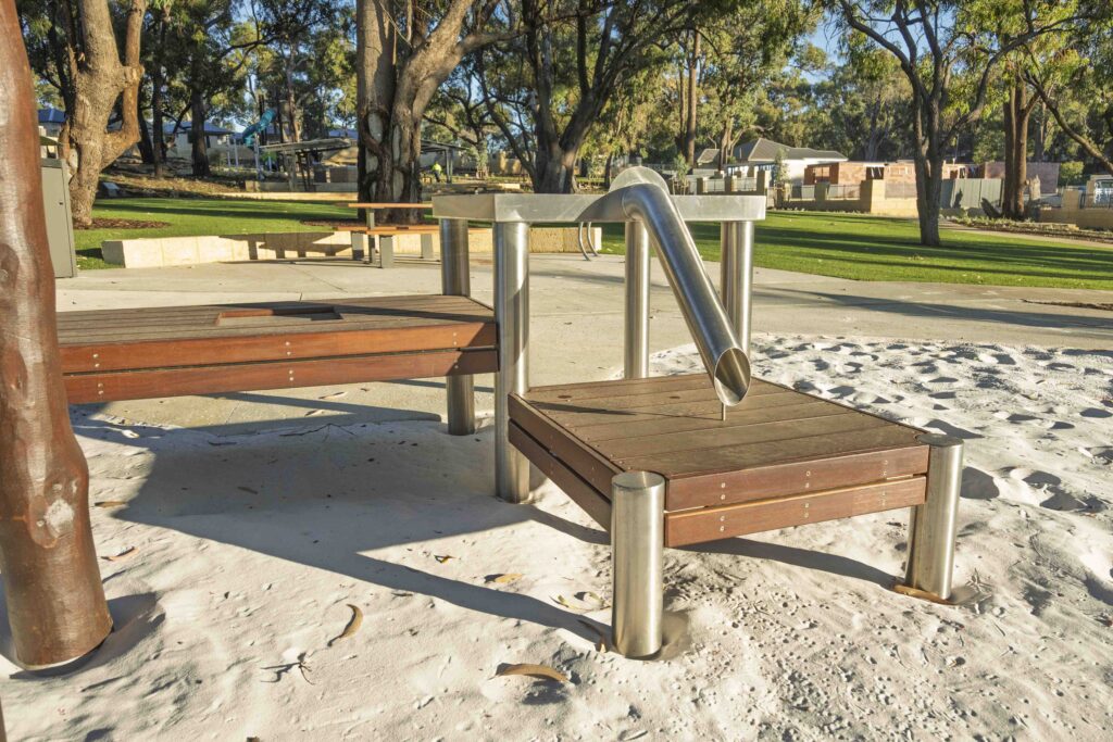 Raised Jarrah timber deck platform with stainless steel rail in sand play area at Hathaway Reserve playground Baldivis