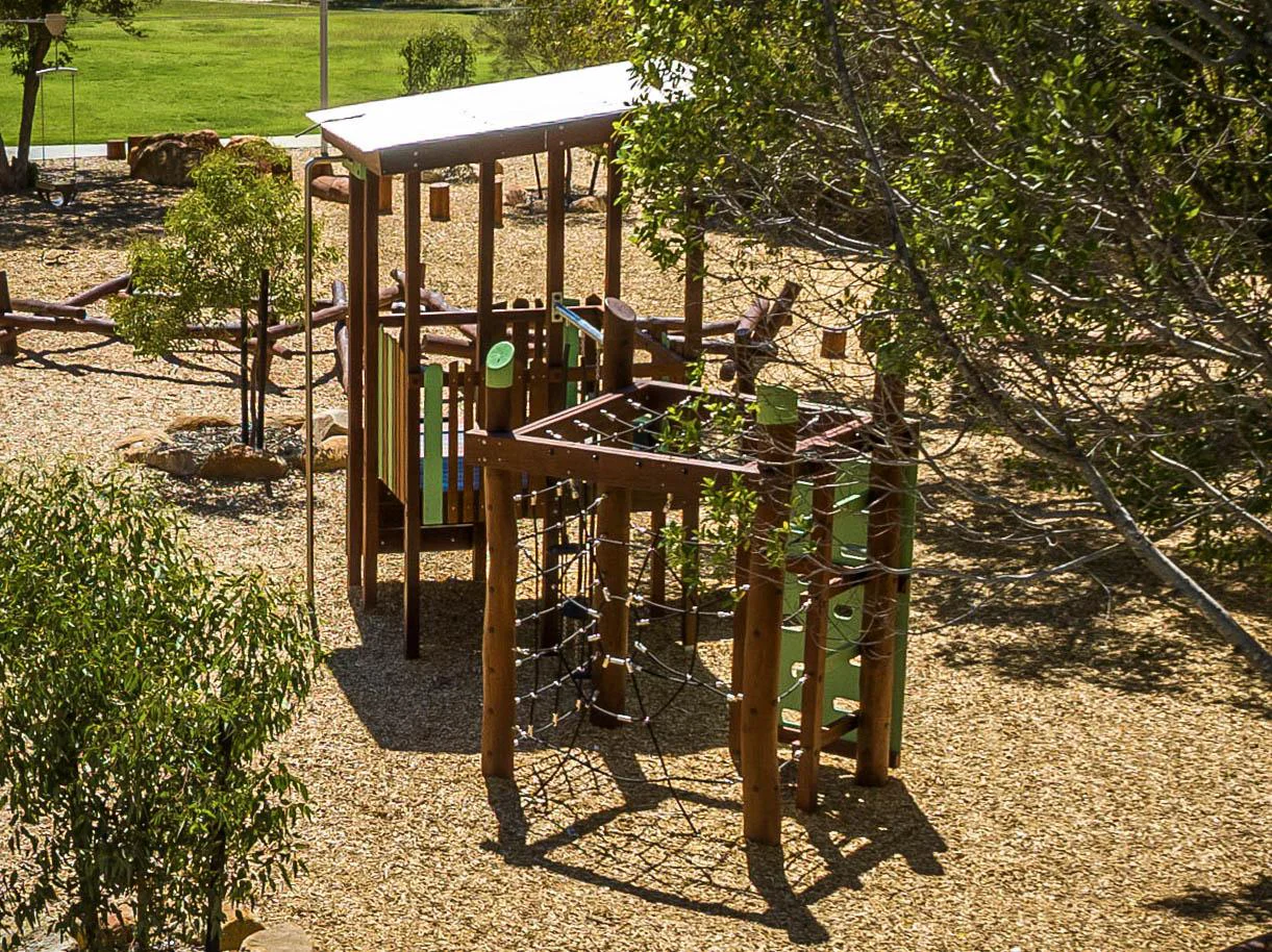 Van Ryt Industries Merredin Combo A Jarrah climbing frame — corrugated roof, coloured footholds, fireman's pole, and feature boards at Merredin WA